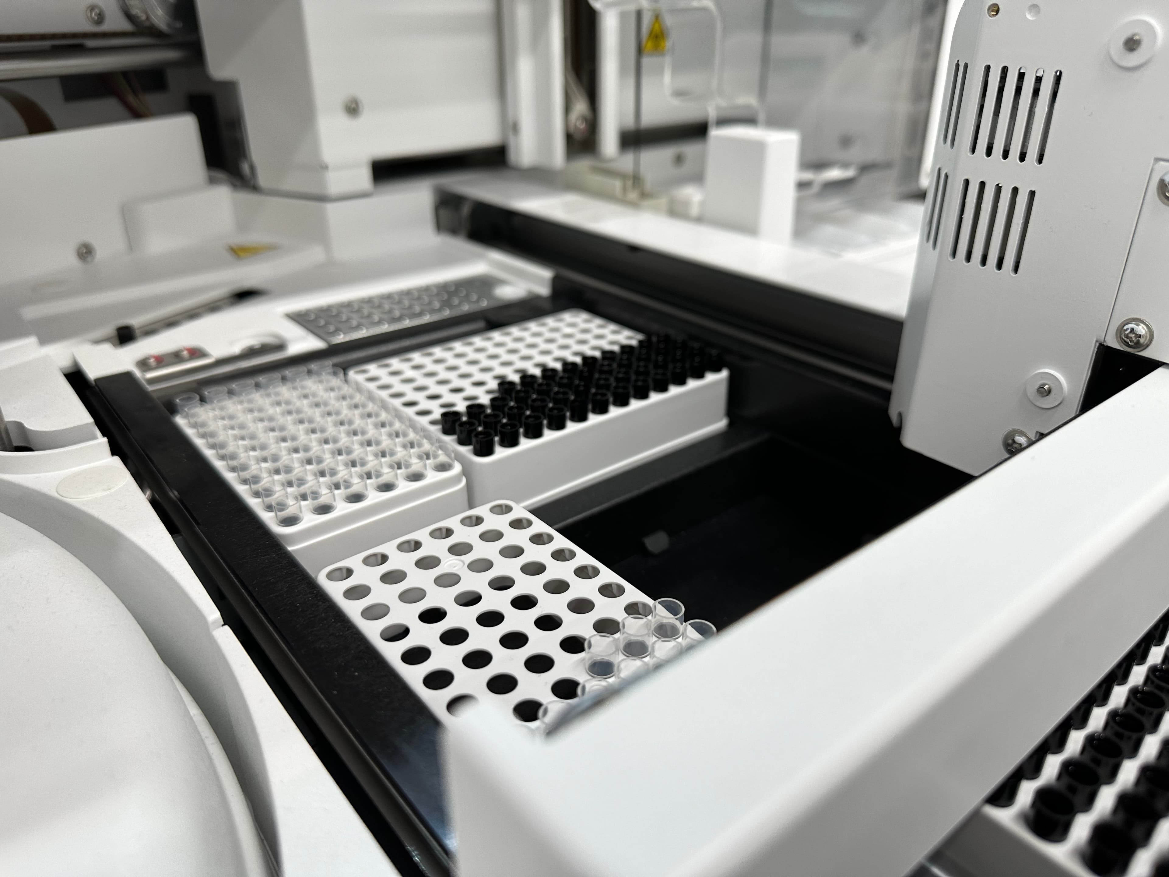 Sample tube racks loaded into the lab's analyzer